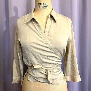 This cream colored wrap top is the perfect fit and style for any outfit.